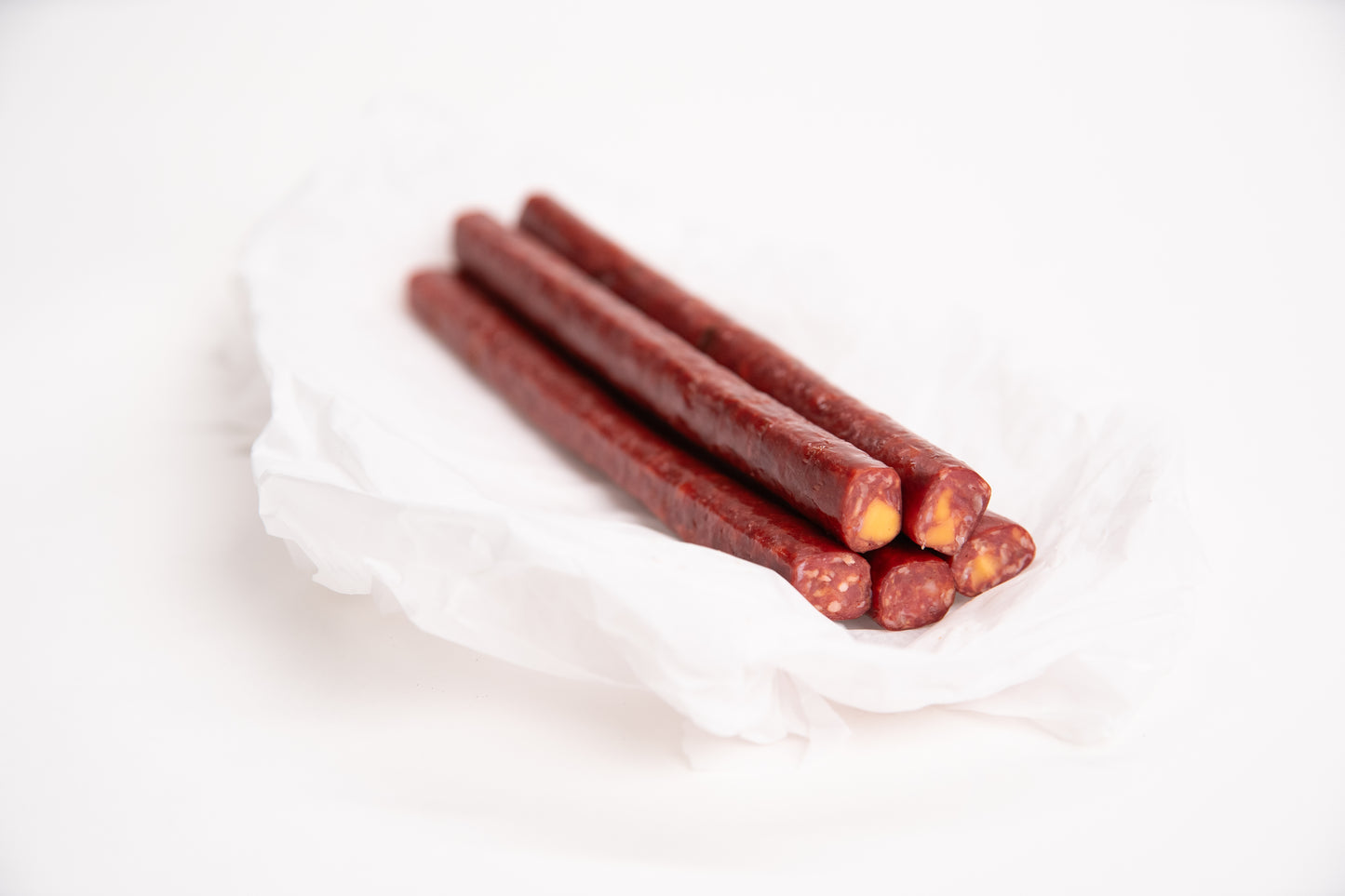 Elk meat snack sticks on a white background