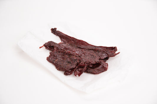 Dried elk jerky on a white background