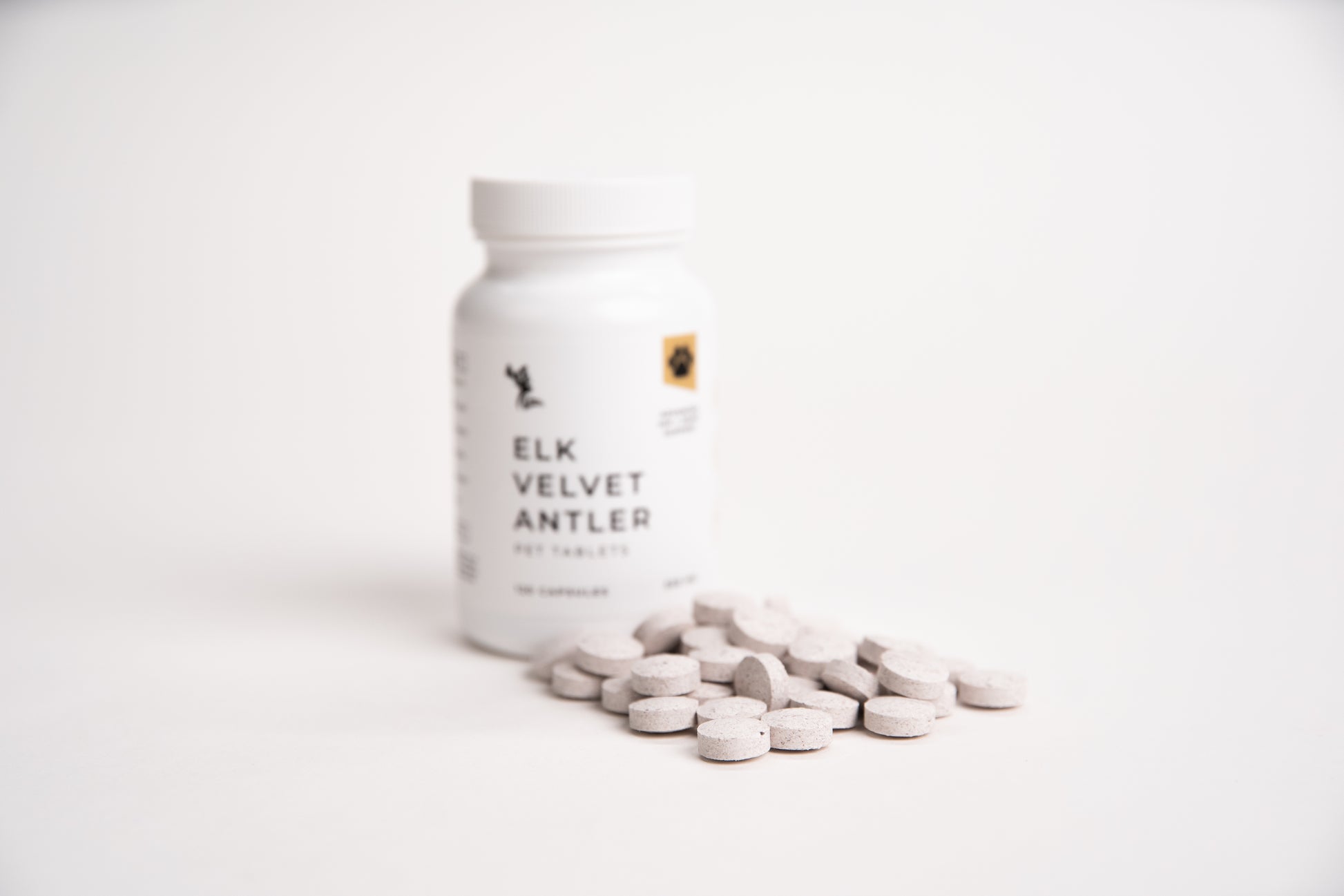 Bottle of Elk Velvet Antler Pet Tablets supplement with tablets on a white background